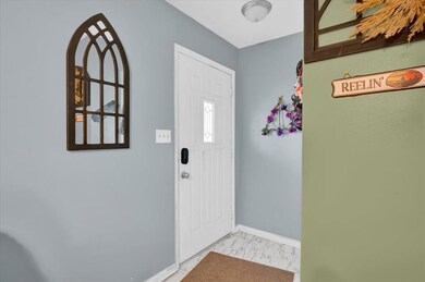 Foyer entrance featuring baseboards and marble fin