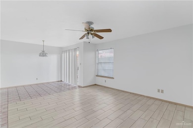 Empty room with a ceiling fan and light wood finished floors