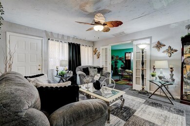 Living room featuring visible vents and a ceiling 