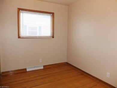 Bedroom 3 with wood flooring.