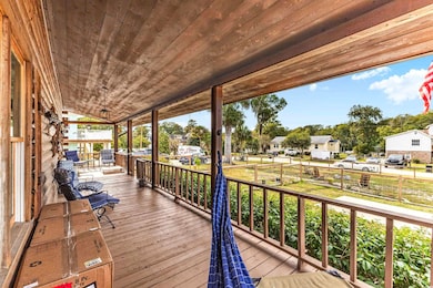 Porch with a residential view and a grill