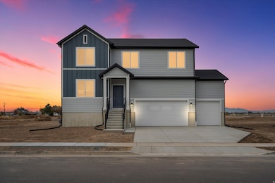 View of front facade featuring board and batten siding, concrete driveway, and an attached garage