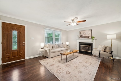 Living room with baseboards, a ceiling fan, dark w
