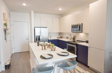 Kitchen featuring white cabinetry, light hardwood 