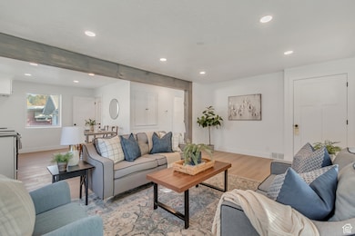 Living room with recessed lighting and wood finished floors