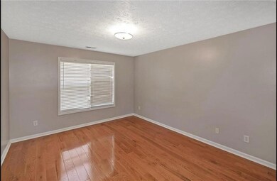 Empty room with baseboards, wood finished floors, 