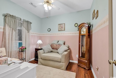 Sitting room featuring dark wood-type flooring and