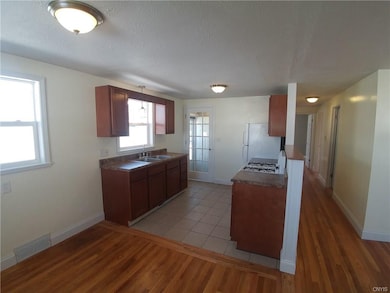 Kitchen with new cabinets, new countertop, new cer