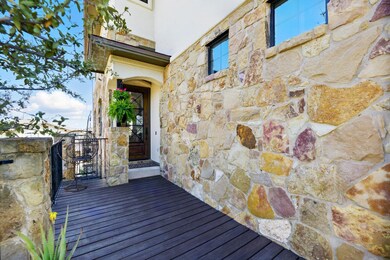 Entrance to property featuring stone siding