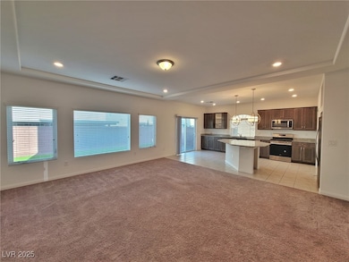 Unfurnished living room featuring light carpet, he