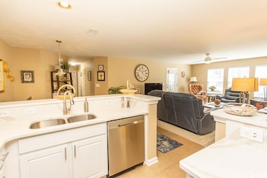 Kitchen featuring sink, white cabinetry, hanging l