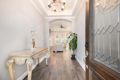 The stunning entryway features coffered ceilings,