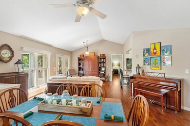 vaulted ceilings and open dining area with living