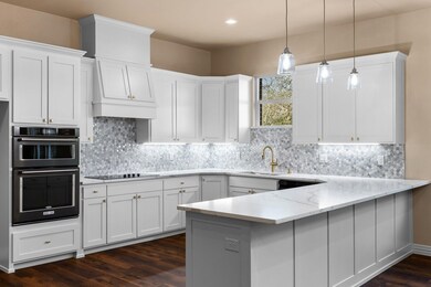 Kitchen featuring light stone counters, sink, deco