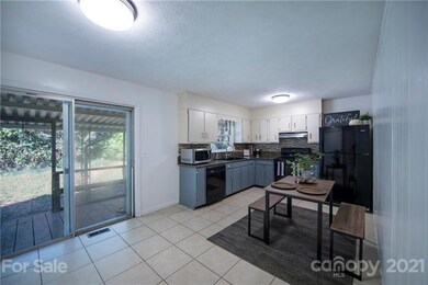 Kitchen is right off the living room and open to covered back porch.
