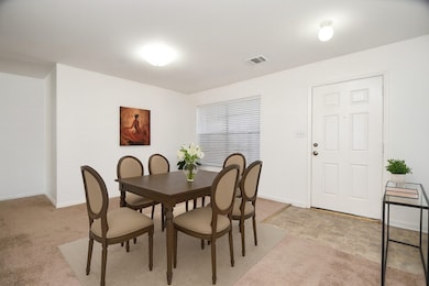 An expansive front window fills the room with natural light. (Another view of the dining room virtually staged with A.I.)