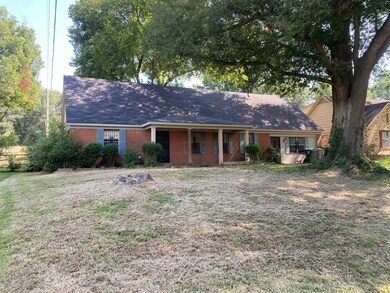 Single story home with a front lawn
