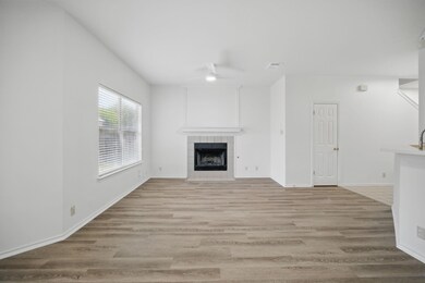 Unfurnished living room with a ceiling fan, a til