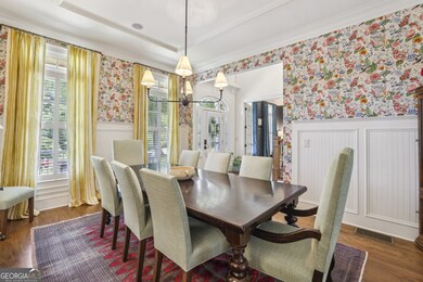 Formal Dining Room with Wainscoting and Oversized Windows adds elegance for entertaining.