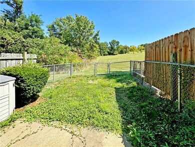 Out the sliding door to the patio and fenced back