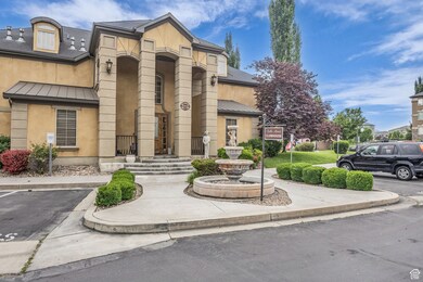 View of building exterior featuring uncovered parking