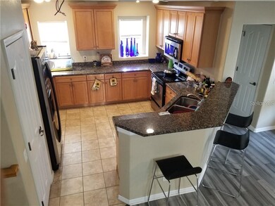 Kitchen has wood cabinets and granite counter tops