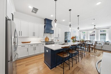 Open floor plan with large kitchen and bar seating at the island.