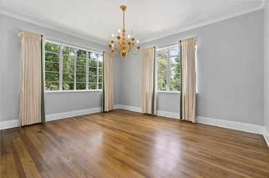 Featuring a chandelier, tall ceilings, and crown m