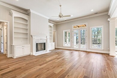 Den area with gas fireplace,bookshelves & cabinets