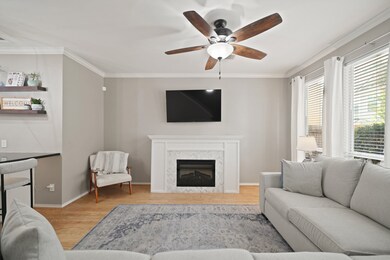 The family room features a decorative built-in electric fireplace that produces heat, accented by a stylish white and gray herringbone tile surround.