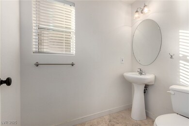 Half bathroom with toilet and tile patterned floor