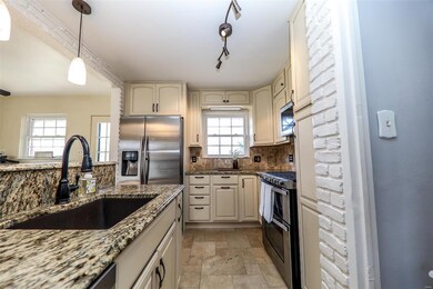Amazing custom kitchen with travertine tile, granite counter tops, stainless appliances and new lighting.