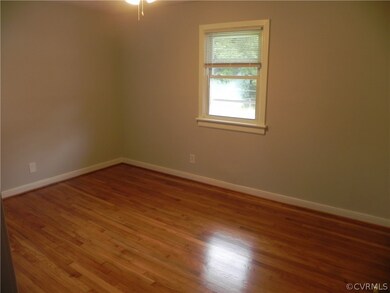 Empty room with hardwood / wood-style floors
