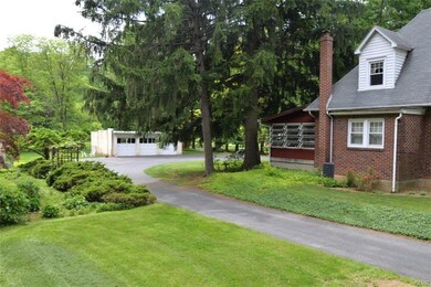 VIEW OF GARAGE AND DRIVEWAY ON LEFT SIDE OF HOME.