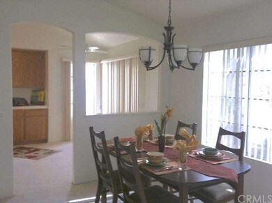 Dining area with arched open divider to kitchen ar