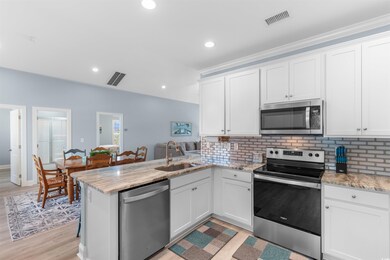 Kitchen featuring white cabinets, visible vents, a