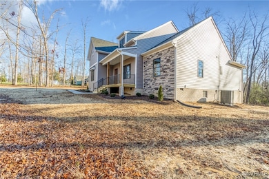 View of side of property with a porch and central