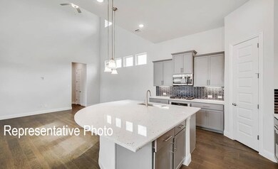 Kitchen featuring an island with sink, stainless s