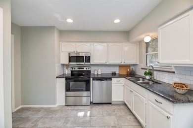 Kitchen with granite counter tops and new stainless appliances