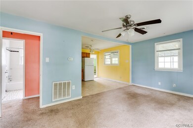 Carpeted empty room with ceiling fan