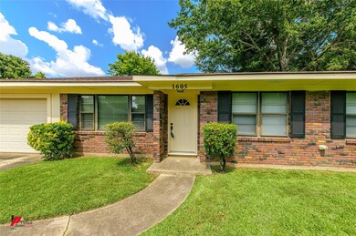 Ranch-style home with a garage and a front yard
