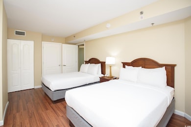 Bedroom featuring visible vents, a closet, baseboa