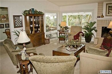Spacious living room  w/cozy fireplace & a vaulted
