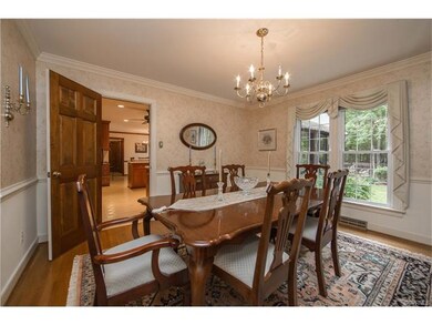 Dining Room with hardwood floors, crown and chair 