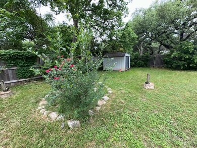 View of yard with an outdoor structure, a storage
