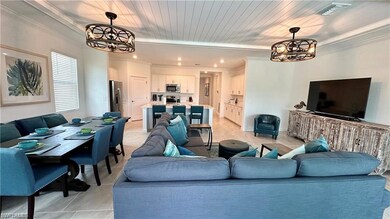 Living room featuring ornamental molding, light ti