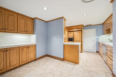 Kitchen with tile flooring, tile countertops/backs