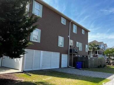 Rear view of property with a garage