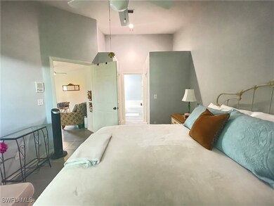Bedroom with a towering ceiling and ceiling fan