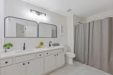 Upstairs, the Primary Suite features a Vaulted Ceiling, a Spa-Like Bathroom with a Stone Dual Vanity, Tub/Shower Combo, and a Large Walk-In Closet